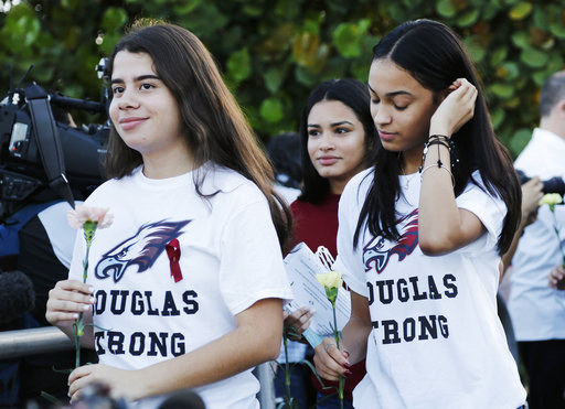 Students wore t-shirts emblazoned with the words "Douglas Strong" and carried flowers as they made their way to school.