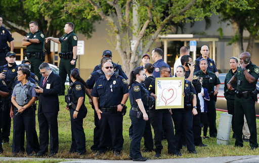 Some officers held signs of love and support as students walked to school.