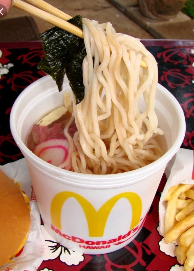 Ramen noodles in a soup cup with radishes and other condiments