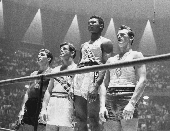 Cassius Clay wins Olympic gold for light heavyweight boxing in 1960.