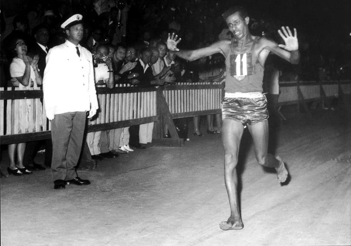 Abebe Bikila of Ethiopia runs the men's marathon final while completely barefoot in 1960 — and wins.