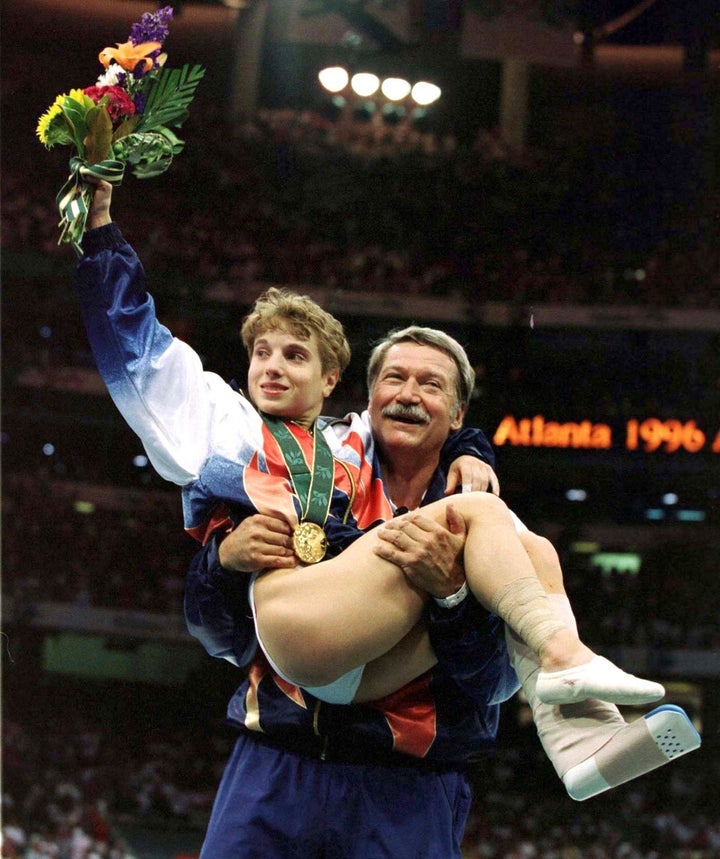 An injured Kerri Strug takes home gold for the USA in 1996.