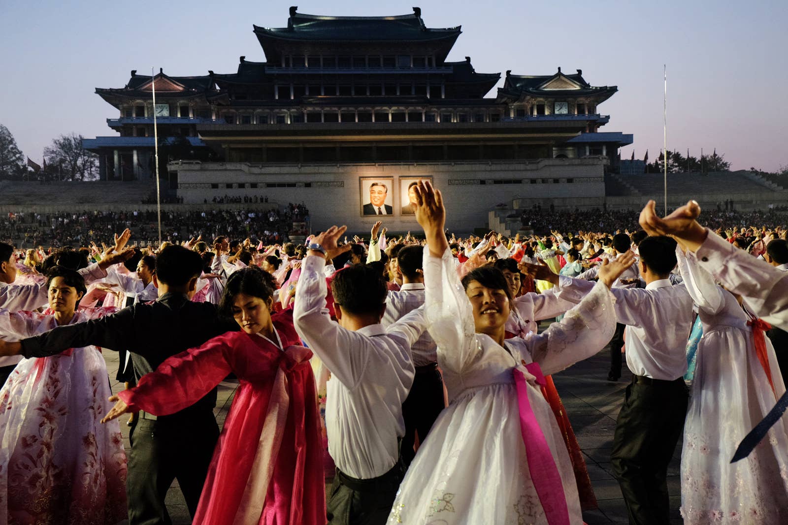 Students participate in a mass dance on Kim Il-sung Square in Pyongyang.