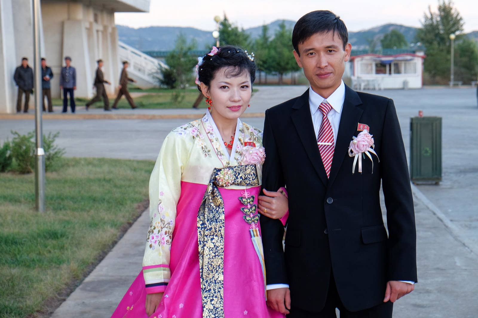 A newlywed couple outside Pyongyang Folklore Park.
