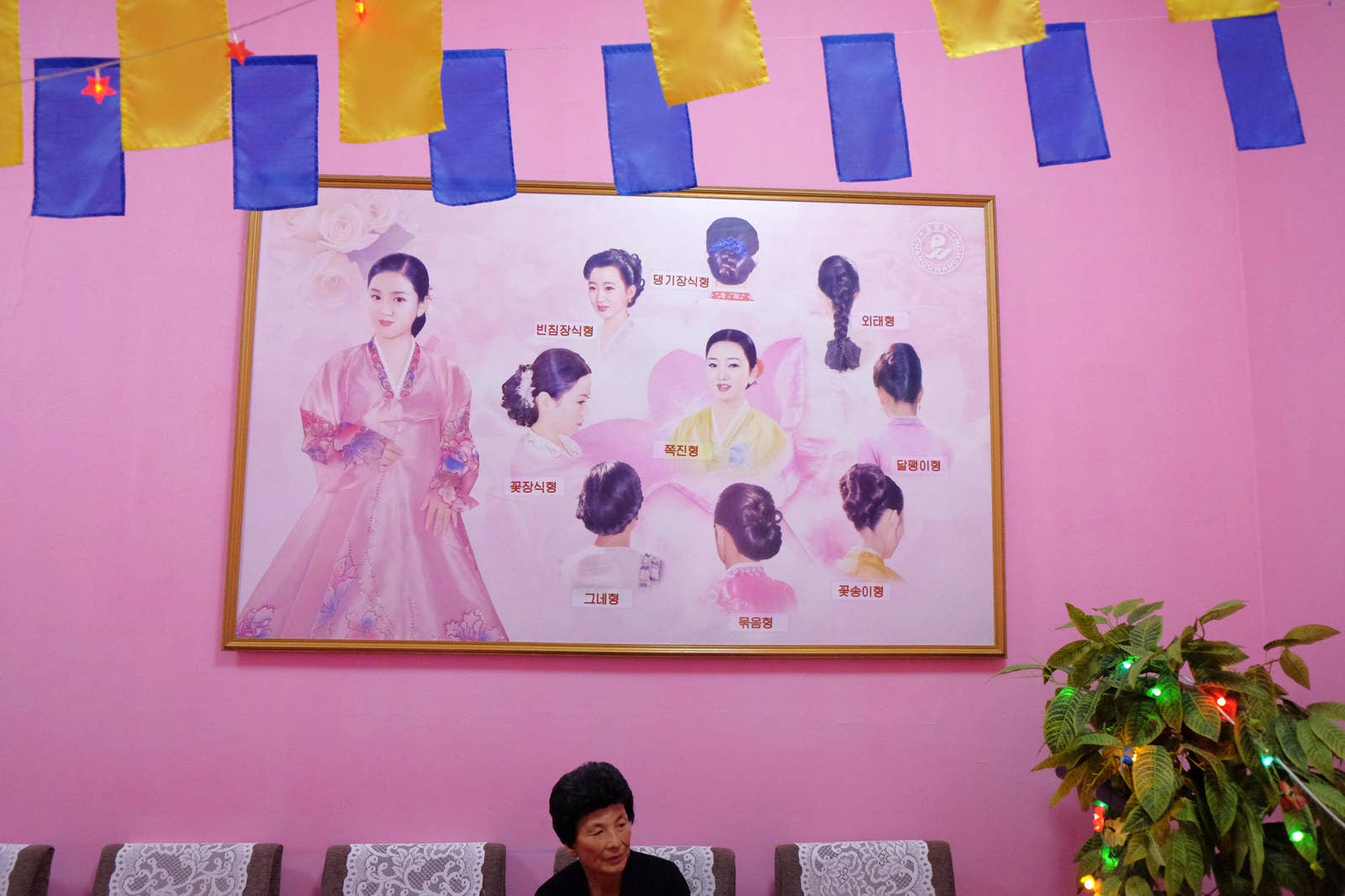 Traditional female Korean haircuts and a customer at a Pyongyang hair salon.