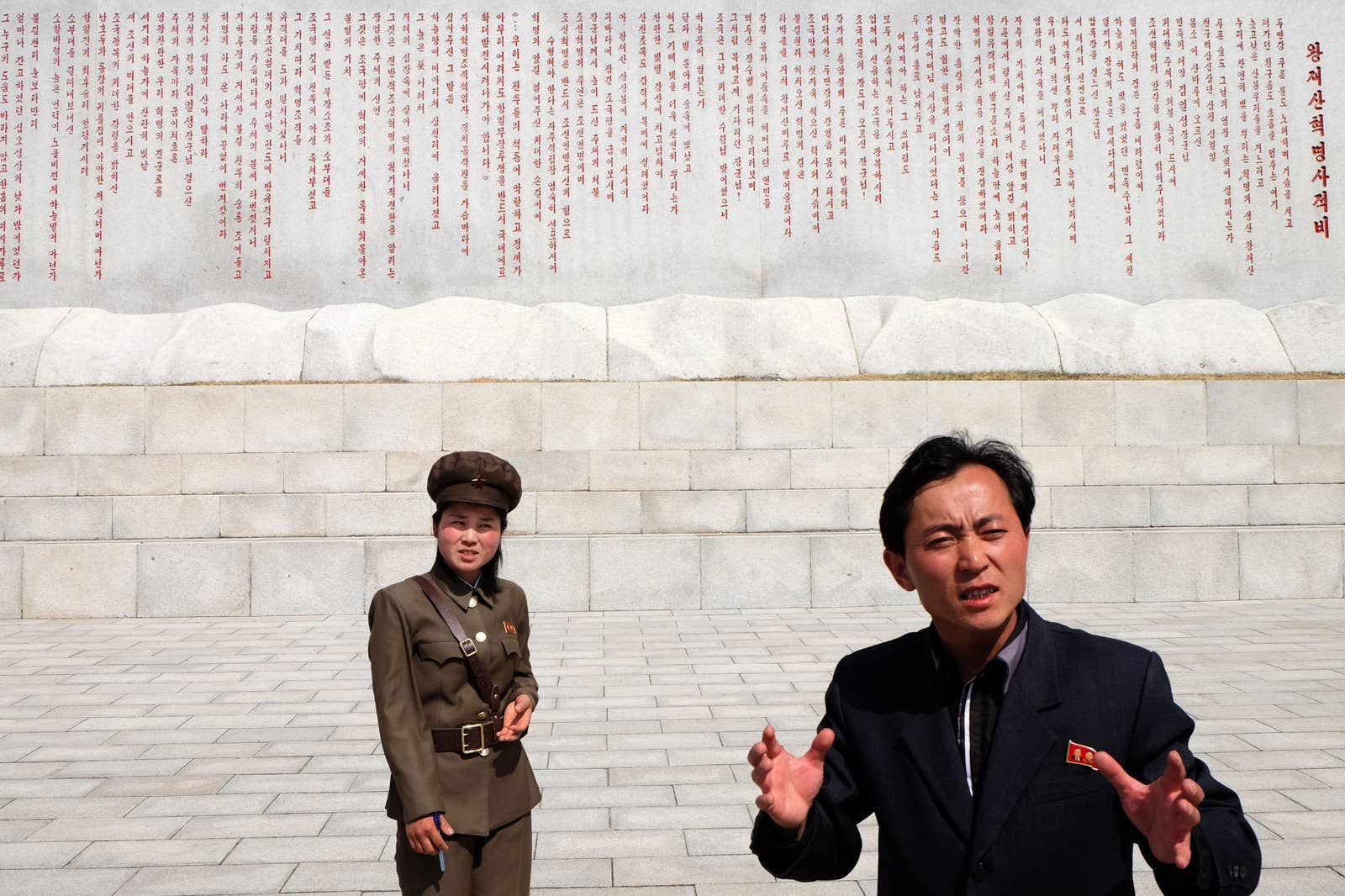 A guide translates a female soldier's comments about the Wangjaesan Monument in North Hamgyong province.