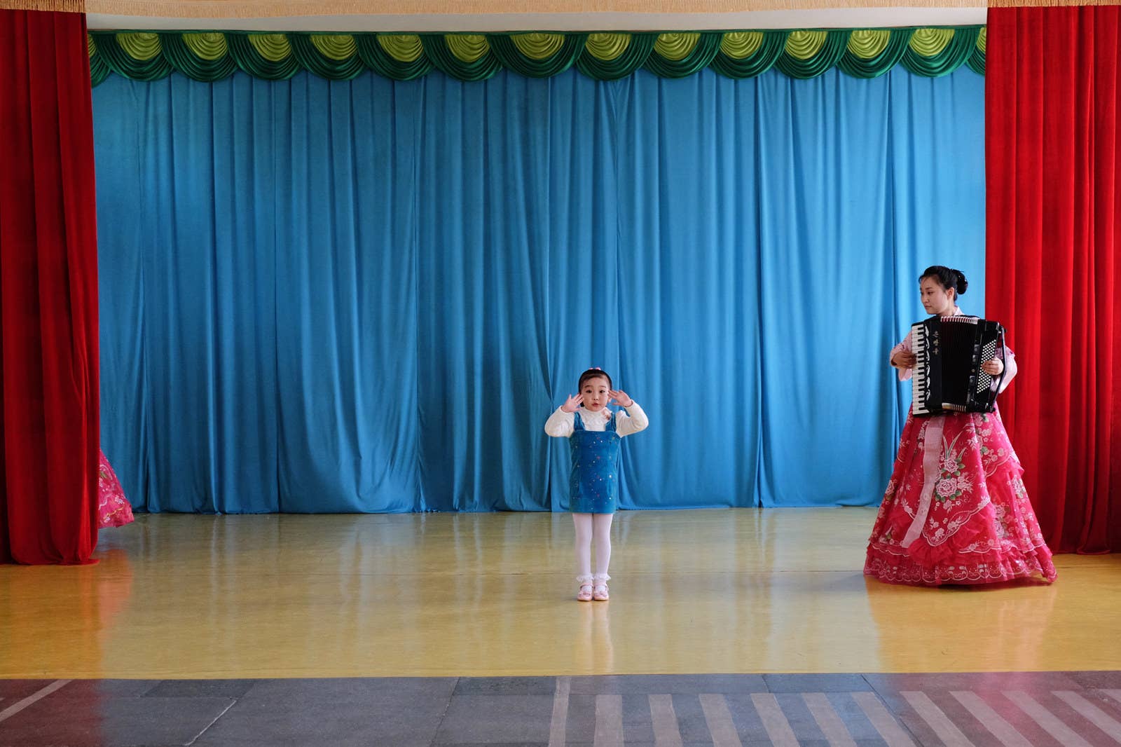 A child sings at a kindergarten performance in Chongjin, North Korea. Talented children are trained to a very high level from an early age.