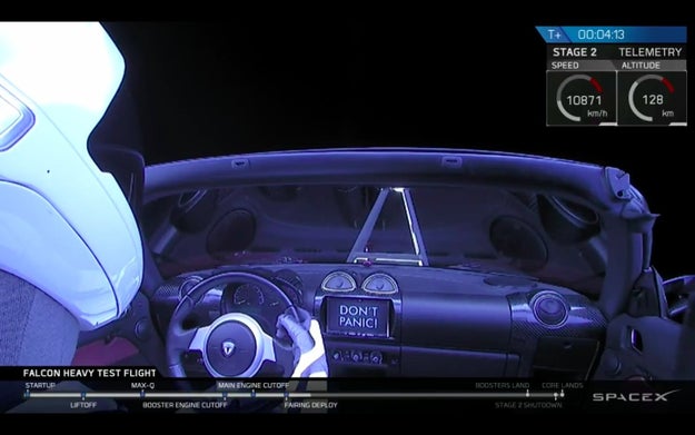 The best part? The screen inside the Tesla reads, "Don't Panic," which is what we all really need to hear right now. Thanks, Elon.