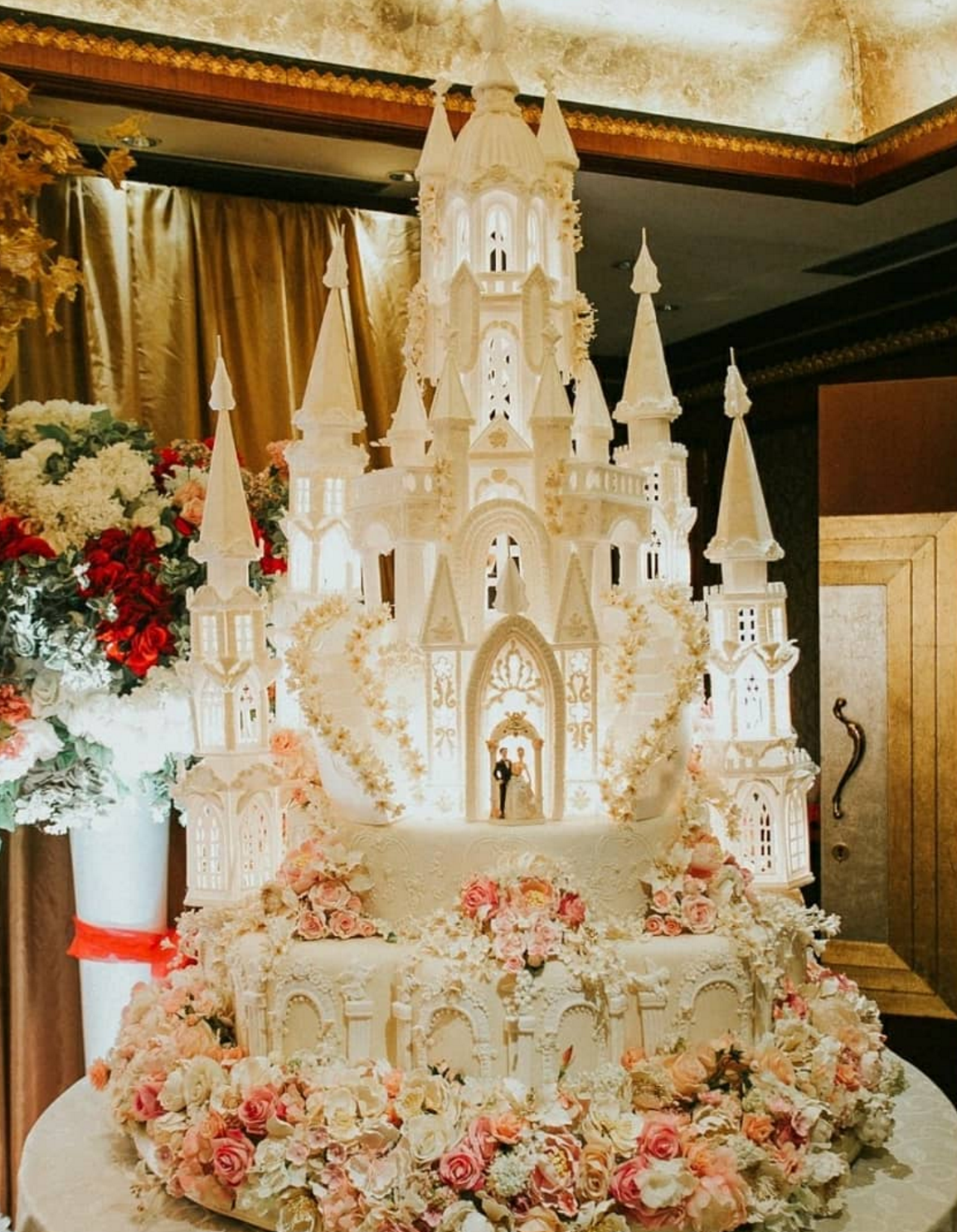 layered and intricate wedding cake with detailed flowers