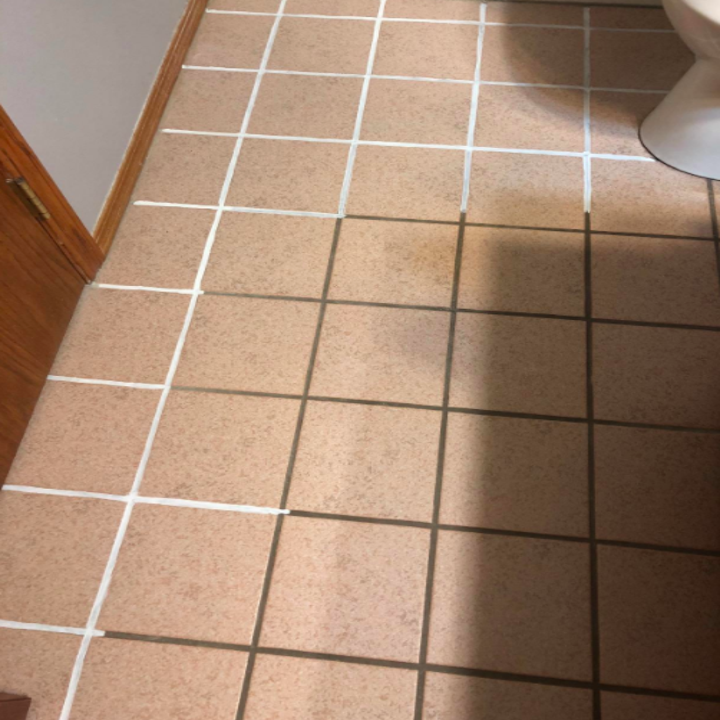 A reviewer's bathroom where the pen appears to have whitened previously brown-colored grout