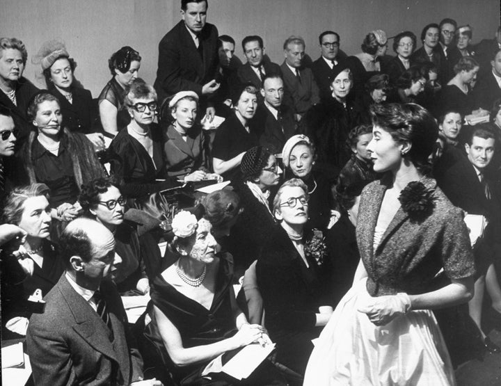 A model shows off her shangtung dress with a tweed jacket during Givenchy show in 1952.