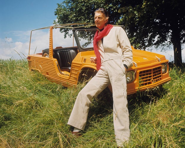 Givenchy, leaning against a Citroen Mehari in a country field, poses while wearing his designs for an issue of Vogue in 1969.