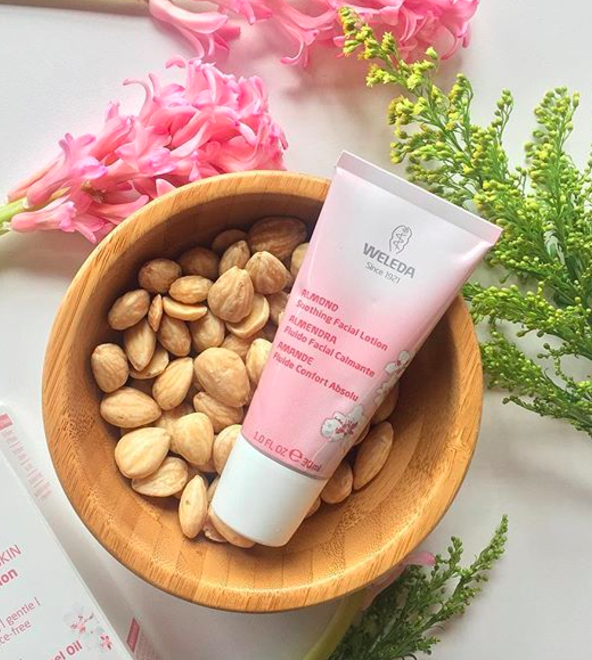 the pink tube of moisturizer in bowl with nuts