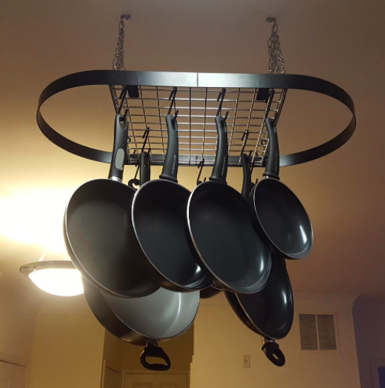 Promising review: "We have a very small galley style kitchen. We don't have much cabinet space and are always shoving pots and pans wherever we can fit them. We decided to get a ceiling rack. I was worried that because it is small, it would be flimsy. It isn't! it is a little powerhouse. It assembled like a charm with clear directions. Hanging it is a two person job because it is awkward not due to any issue with the rack. It holds our everyday pots and pans. It also came with lots of hooks, something that others didn't. For our space this is perfect and I am happy with the quality. If we were to ever get more space I would check into this brand for a bigger rack before looking elsewhere." —RccPrice: $34.98+ (available in four colors)