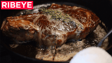 A gif of a steak being basted with butter