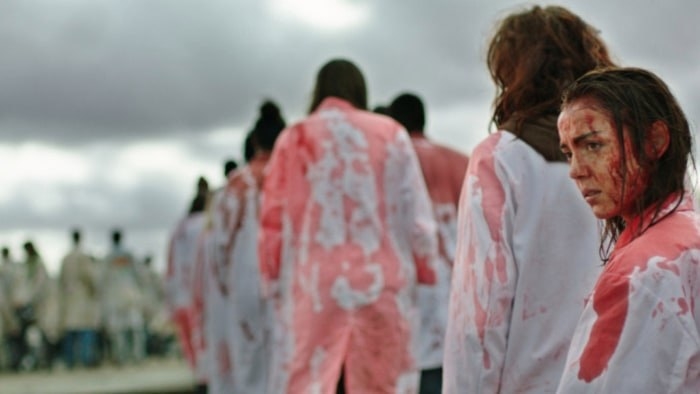 People wearing blood-drenched white coats
