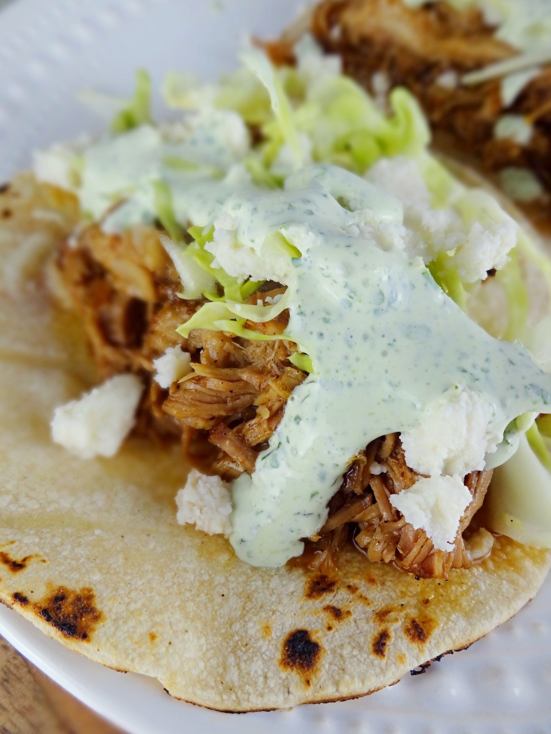 Guinness Braised Pork Tacos with crema and cabbage.