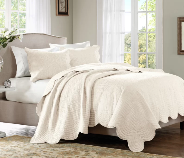 Promising review: "I love this bedspread. I purchased a full/queen for a queen platform bed (no boxspring). A king would have definitely been too big. The queen is big enough that I wouldn't have needed a bedskirt if I didn't want to use one. I was pleasantly surprised that the scalloped edge goes across the top of the bedspread, too. The quilting on top is lovely and the color is a perfect cream. I put a duvet comforter underneath for winter, and it will be perfect alone for California summers. It is great for a small room as the color is unobtrusive, but the details dress it up." —PamelaGet it from Wayfair for $61.99+ (available in two sizes and colors) or from Birch Lane for $75.99+ (available in two sizes and colors).