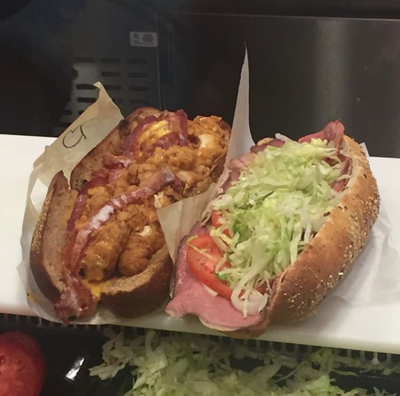 Sub with chicken tenders and one with other meat, tomatoes, and lettuce