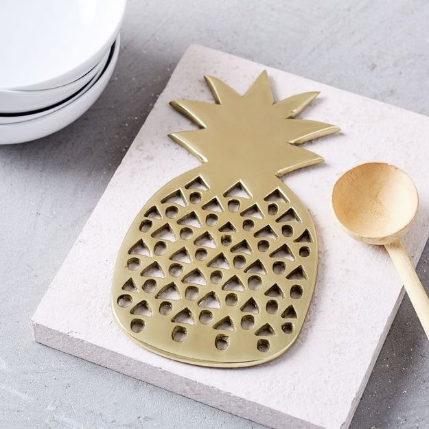 A golden pineapple trivet that'll look great on the table even when it's not in use.