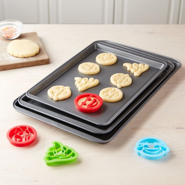 A non-stick cookie sheet set with emoji cookie cutters for baking treats as tasty as they are Instagrammable.