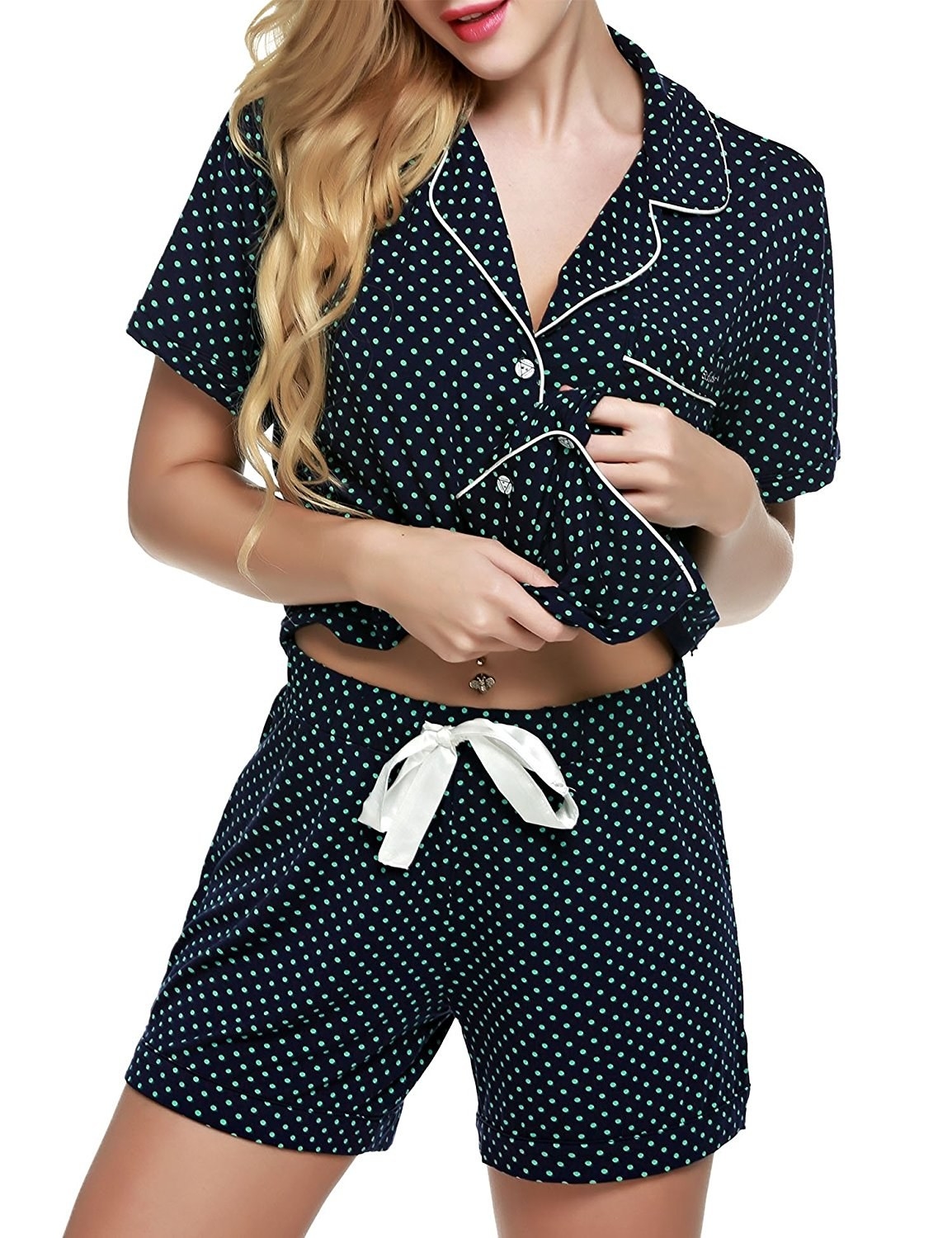 person wears pajamas in dark blue with green dots 