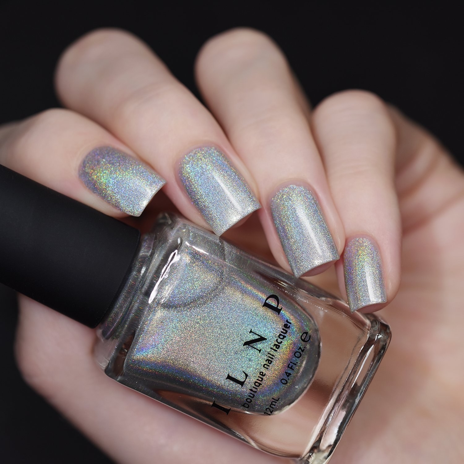 holographic nail polish bottle and nails painted with polish 