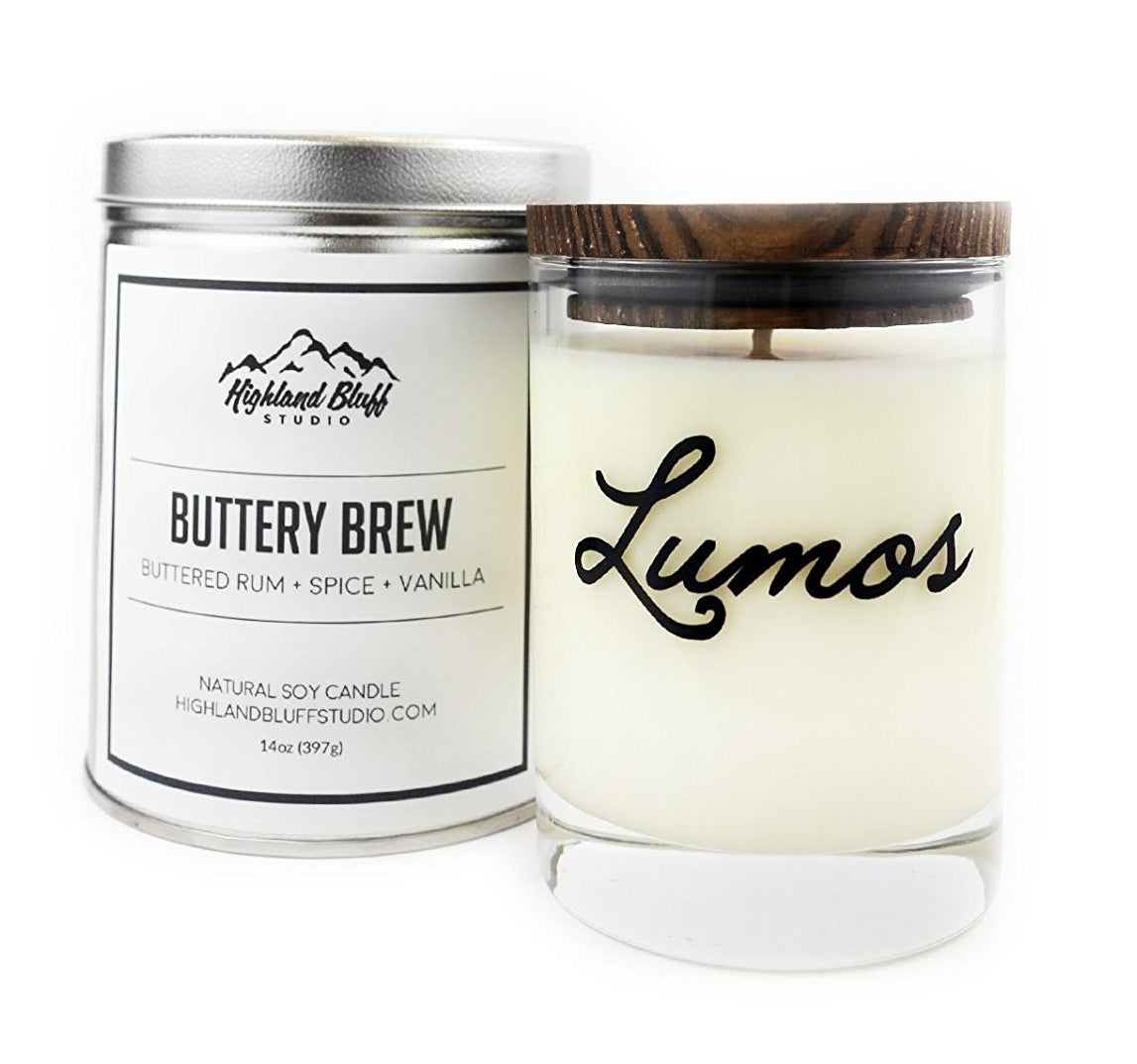 candle with wooden topper that says lumos next to box that says buttery brew 