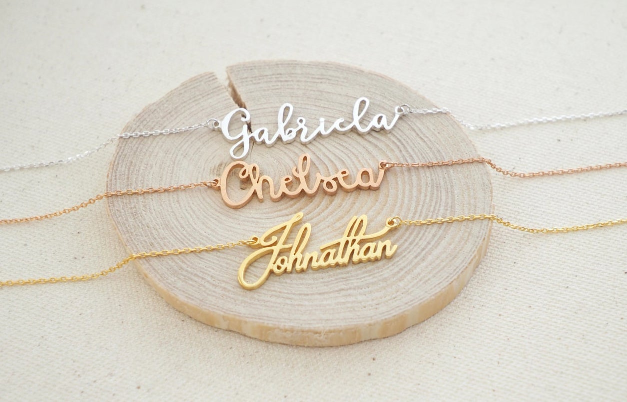 personalized necklaces reading gabriela, chelsea, and johnathan in three different metals 