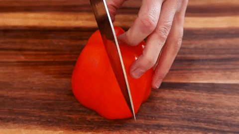 Speaking of messes, say farewell to bell pepper seeds taking over your counter and your evening (HOW AM I STILL CLEANING THESE UP?!). Cut ~around~ the middle so that everything remains nice and compact — and will end up in the garbage faster than your food is in your mouth.