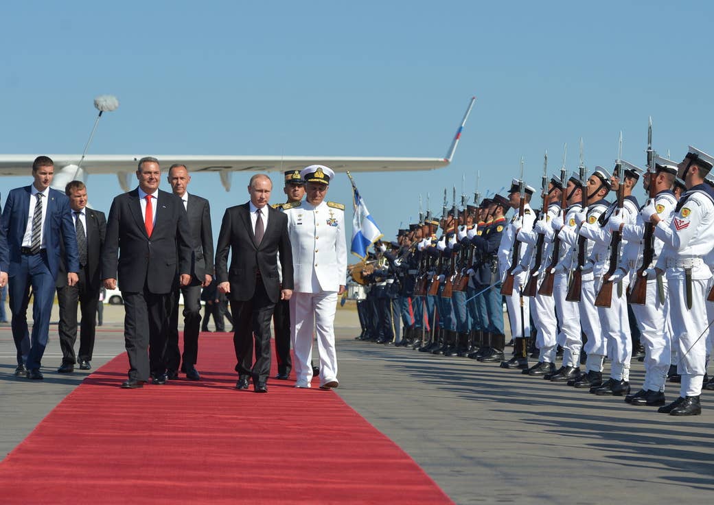 Kammenos and Russian President Vladimir Putin during an arrival ceremony at the Athens Airport.