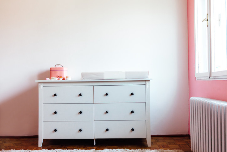 A kitchen dresser with various small items, next to a window with natural light