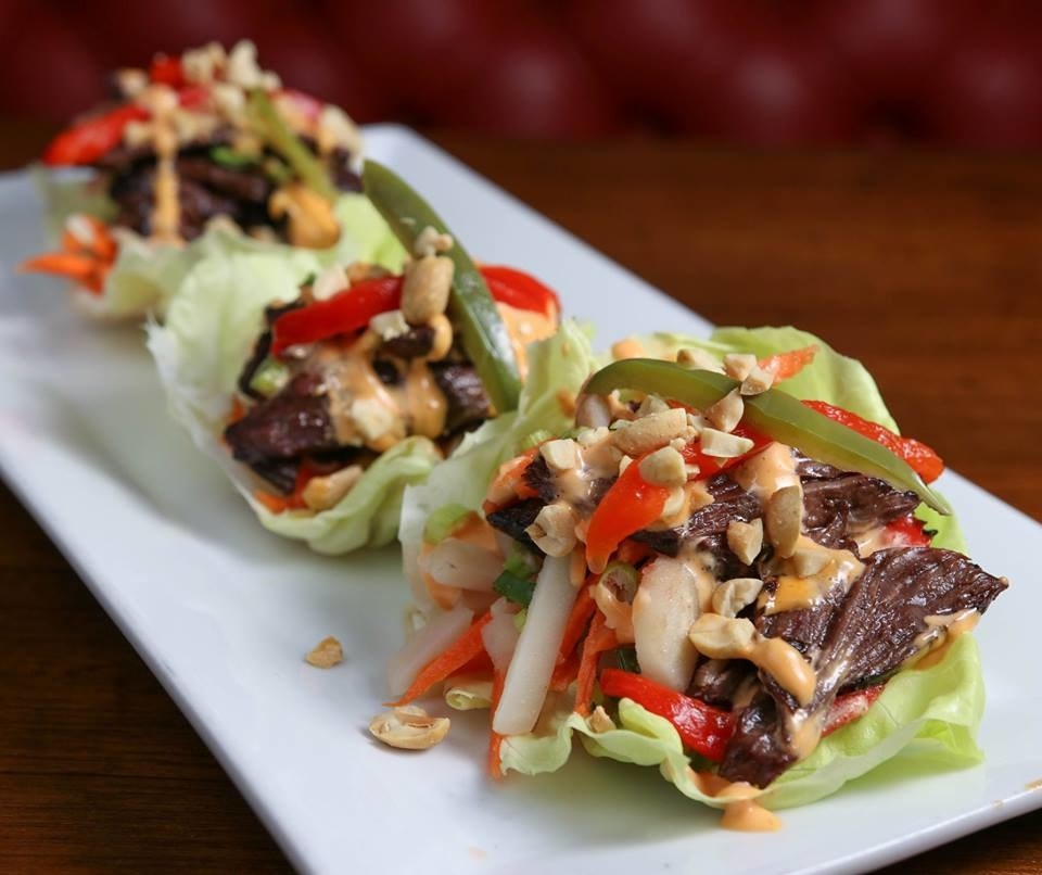 A unique twist on Korean wraps, the Lettuce Wraps (K-Town Style) features tender hanger steak marinated in sweet soy sauce, accompanied by pepper slaw, peanuts, and sriracha aioli all wrapped in lettuce.