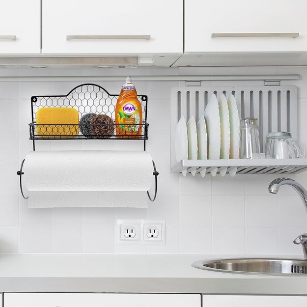 A cute paper towel holder nestled below a convenient shelf for other frequently used kitchen items, like dish soap and sponges.