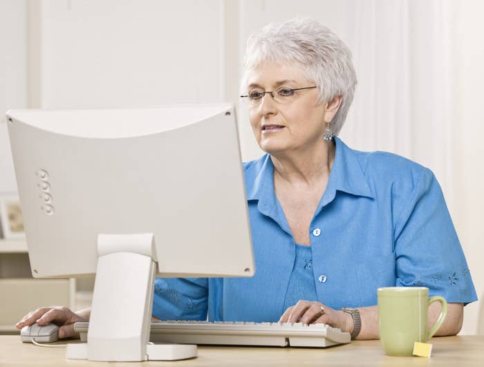 A woman looking at a computer screen