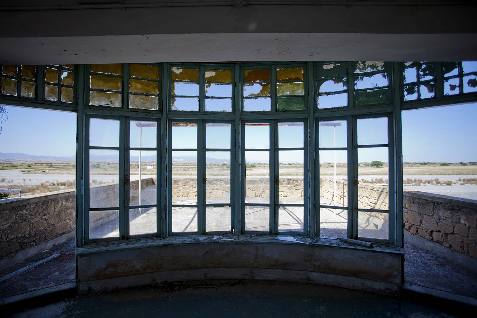 A view from the broken windows of a control tower for the runway.