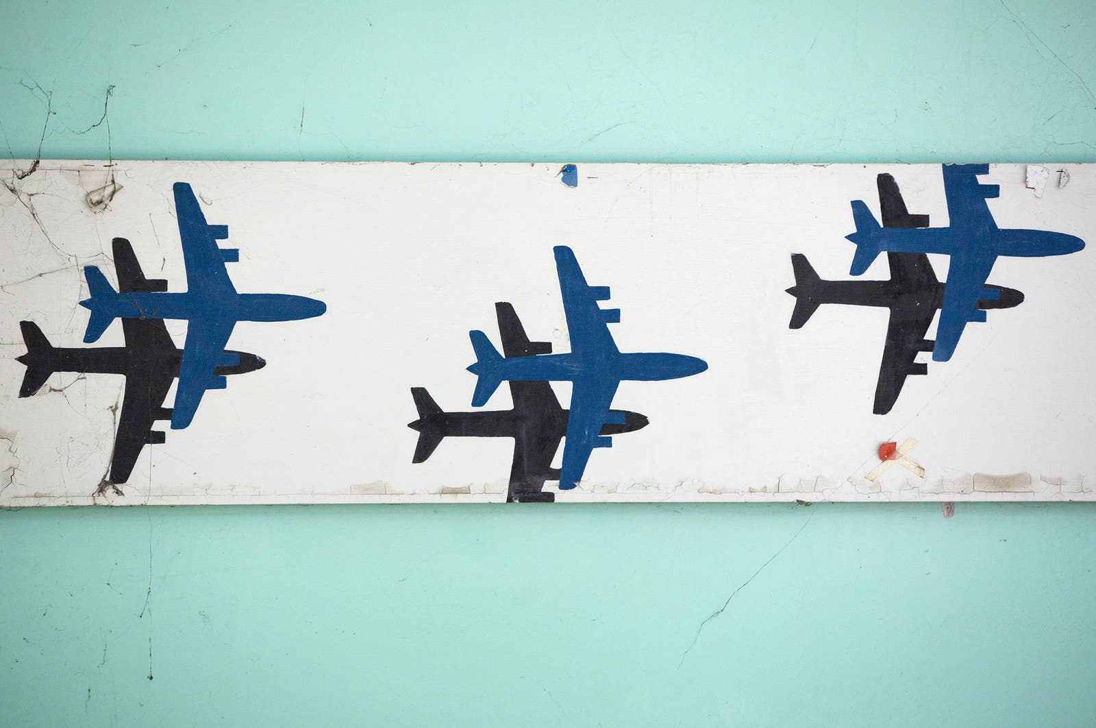 Images of airplanes decorate a wall.