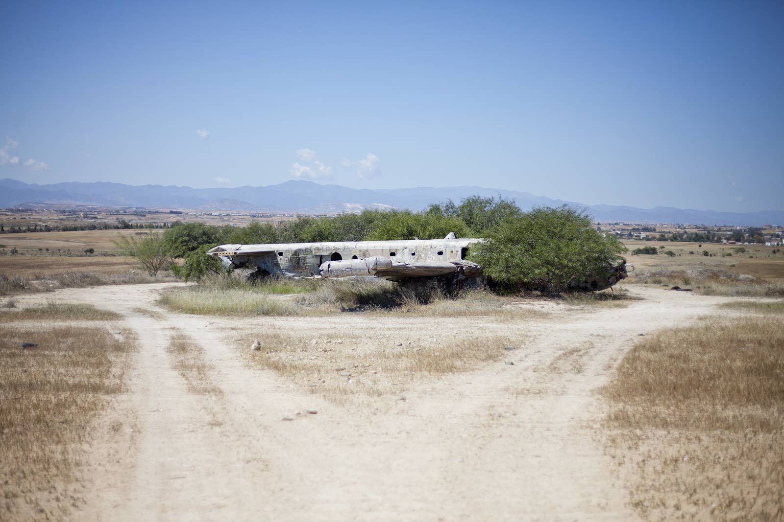 Remains of an Avro Shackleton aircraft is reclaimed by brush and wilderness.