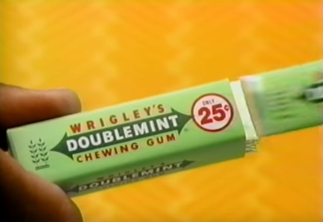 A screenshot of a hand pulling out a stick of Wrigley&#x27;s Doublemint Chewing gum.
