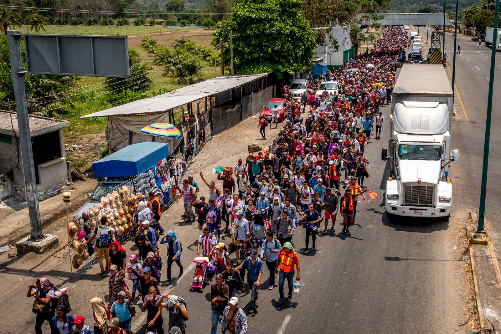 Migrants cheer after clearing the first immigration checkpoint in Chiapas.