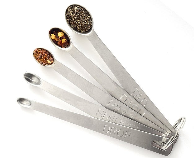 A set of five ~unconventional~ measuring spoons, including options for a "tad," "pinch," and "dash." Now your family heirloom recipes will actually be consistent across the generations.