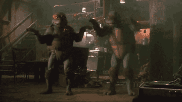 A GIF from the 1990 TMNT movie the features Michelangelo and Donatello dancing.