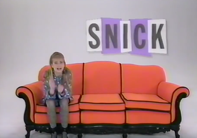 Clarissa sitting on the orange with the SNICK logo above it.