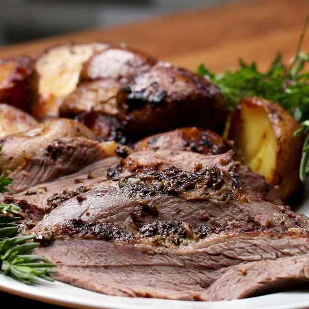 10 servingsINGREDIENTS3.6 kg (8 lb) bone-in lamb roast with fat cap12 cloves garlic, divided120 g (1/2 cup) olive oil80 g (1/3 cup) whole grain mustard, plus more for serving1 lemon, juiced10 sprigs fresh rosemary, stemmed and leaves finely chopped, plus whole sprigs for serving10 sprigs fresh thyme, stemmed and leaves finely chopped, plus whole sprigs for serving1 1/2 tablespoons sea salt1 tablespoon freshly ground black pepper180 mL (3/4 cup) dry white wine1.1 kg (2 1/2 lb) yukon gold potato, halved flaky sea salt, for sprinklingPREPARATION1. 2-3 hours before roasting, prepare the lamb. Use a small, sharp knife to make 15 to 20 incisions, each about 2 inches (5 cm) deep, through the fat cap on top of the meat. Thinly slice 3 cloves of garlic and use your fingers to press the slices into the incisions.2. In a blender, combine the remaining 9 garlic cloves, the olive oil, mustard, lemon juice, rosemary leaves, thyme leaves, salt, and pepper. Blend until a paste forms.3. Spread the paste evenly all over the lamb. Let marinate at room temperature for 2 to 3 hours.4. Preheat the oven to 425°F (220°C).5. Place the lamb on a roasting rack in a roasting pan and pour the wine into the bottom of the pan. Roast for 15 minutes.6. Remove the pan from the oven and reduce the heat to 325°F (160°C).7. Arrange the potatoes, cut side down, in the roasting pan and place the lamb on the rack on top. Roast for 2 hours, tossing the potatoes and basting the lamb with the roasting liquid halfway through.8. Transfer the potatoes to a platter, baste the lamb again with the remaining pan juices, and return the lamb to the oven. Continue to roast, basting often, until an instant-read thermometer inserted into thickest part of the leg reaches 130°F (for medium-rare), 45 minutes to 2 hours more, depending on thickness. (As a general rule, the lamb should roast 20 minutes per pound for medium-rare).9. Transfer the lamb to a platter and set aside to rest for 20 minutes. While the lamb rests, return the potatoes to the roasting pan, season with flaky salt, and warm in the oven until just heated through, about 20 minutes. Return the potatoes to the serving platter.10. Carve the lamb into ½-inch (1 cm) thick slices and arrange on the platter with the potatoes, garnished with rosemary and thyme sprigs. Serve with whole grain mustard alongside.11. Enjoy!