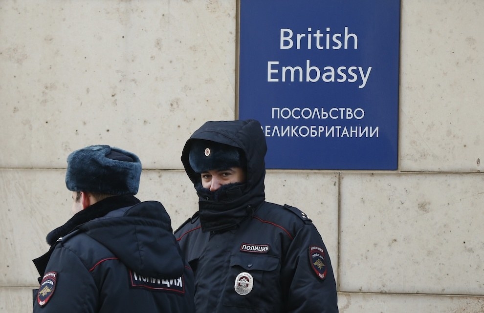 Russian police officers walk outside the British Embassy in Moscow, Russia.
