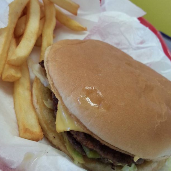 Close-up of a cheeseburger and fries