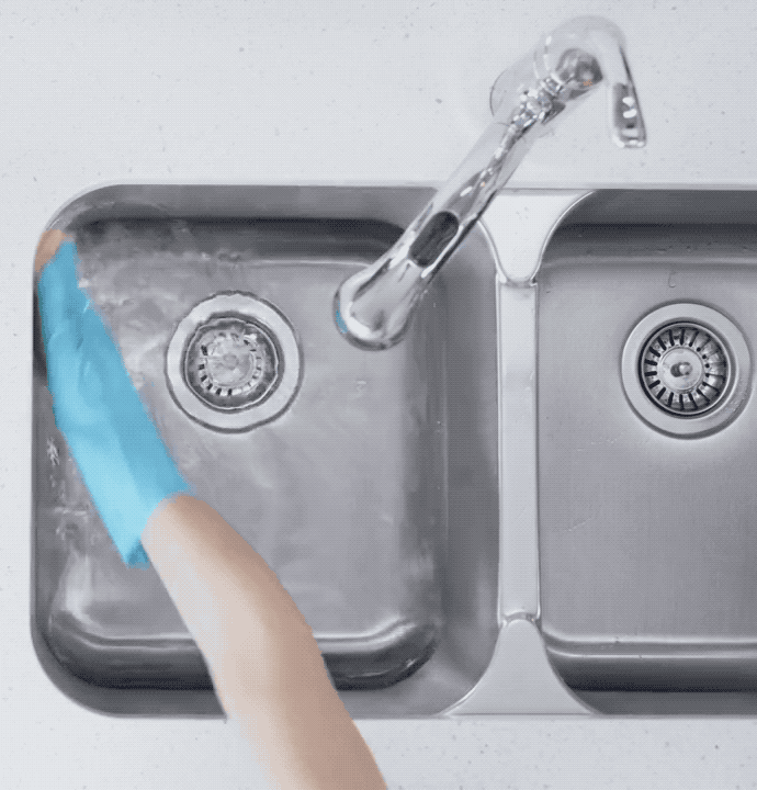 Oh, and don't use that grimy sponge because it's even grosser than your sink. Instead, use a clean, dry rag every time. Treat your sink right!First, wash the surface with hot, soapy water and rinse thoroughly. Then, flood it with diluted bleach (about half a cup in a gallon of water). Make sure you clean the sides of the sink too, and drain after five minutes. Don't rinse out the bleach, just let it air dry or pat it down with paper towels. This process will also totally sanitize your drain, so it doesn't stink to high heaven.