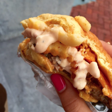 Close-up of a burger with sauce condiments