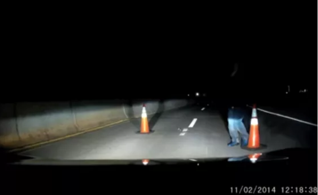 Or maybe it's this video of a suspicious man who tries to stop a car in the middle of a highway late at night.