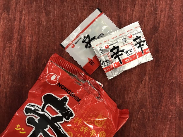 Here's the ultimate instant ramen shortcut: First, cut open the bag about halfway, and take out the toppings and soup packets.